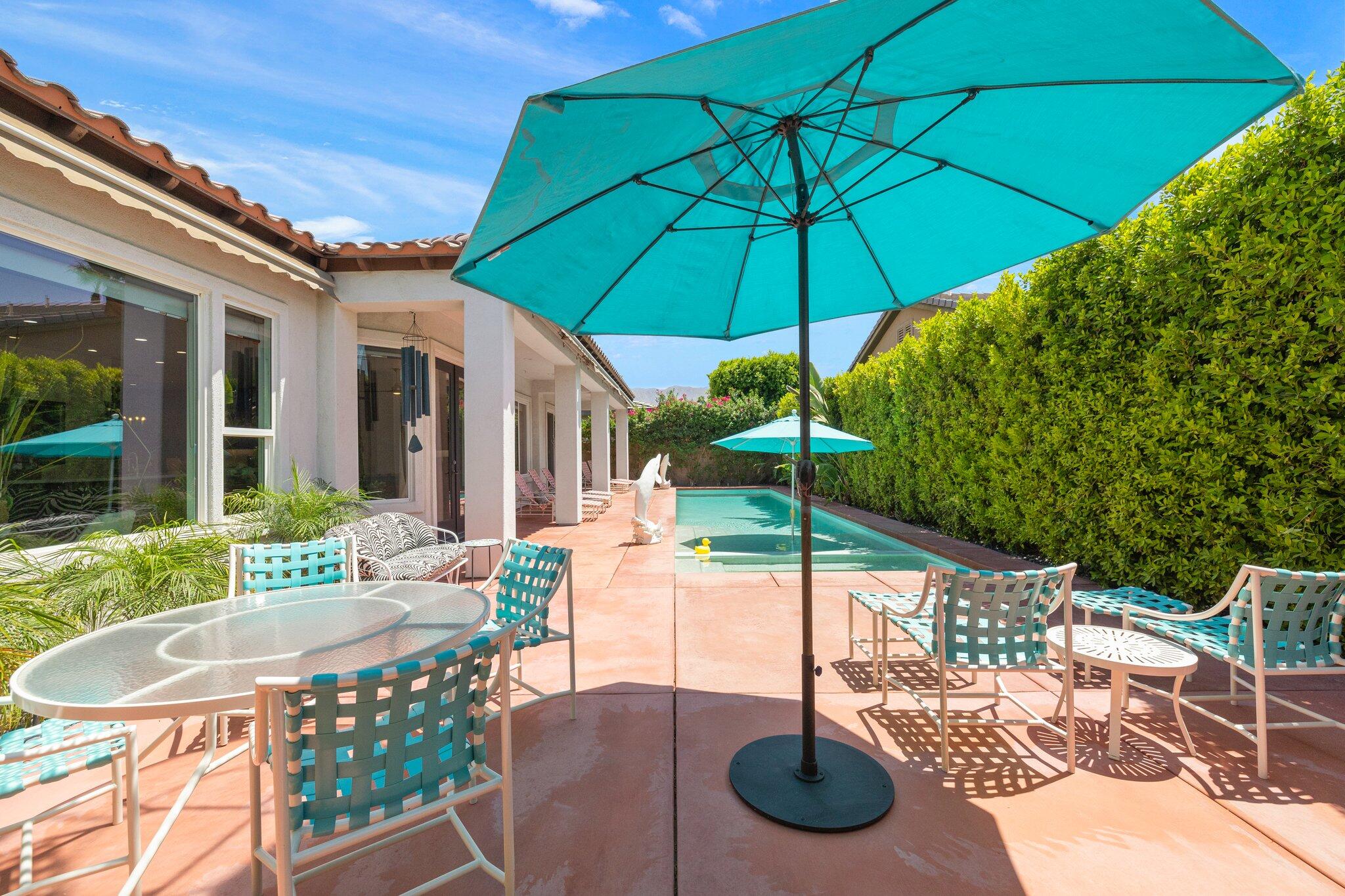 61185 Soaptree Drive La Quinta, CA 92253 - Photo 37 of 51 a patio with a patio table and chairs