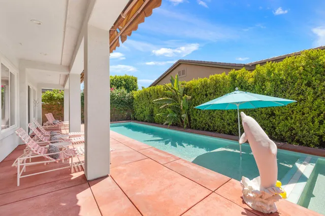 a view of a patio with table and chairs potted plants