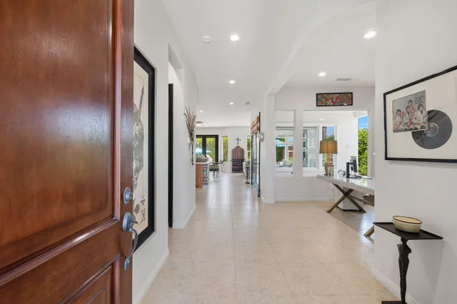 a view of a hallway with wooden floor and furniture