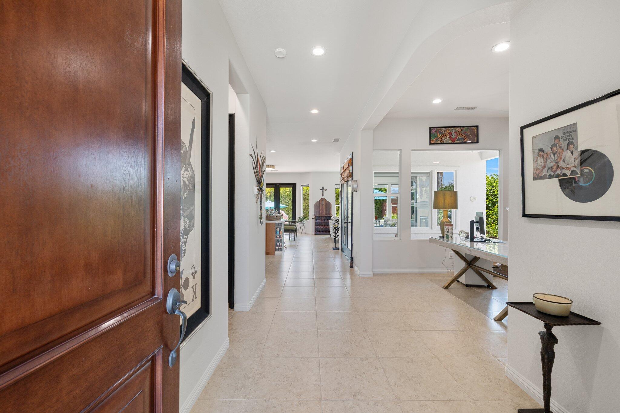 61185 Soaptree Drive La Quinta, CA 92253 - Photo 4 of 51 a view of a hallway with wooden floor and furniture