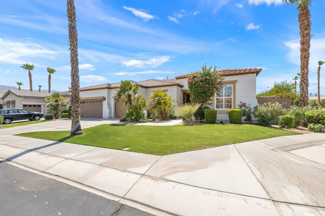 a view of a house with a garden and pathway