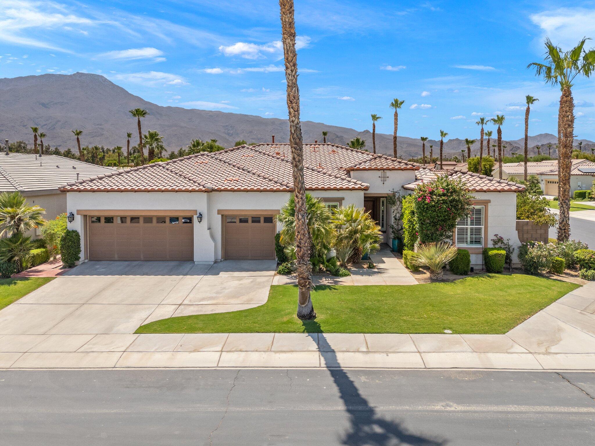 61185 Soaptree Drive La Quinta, CA 92253 - Photo 49 of 51 a view of a house with a garden and pathway