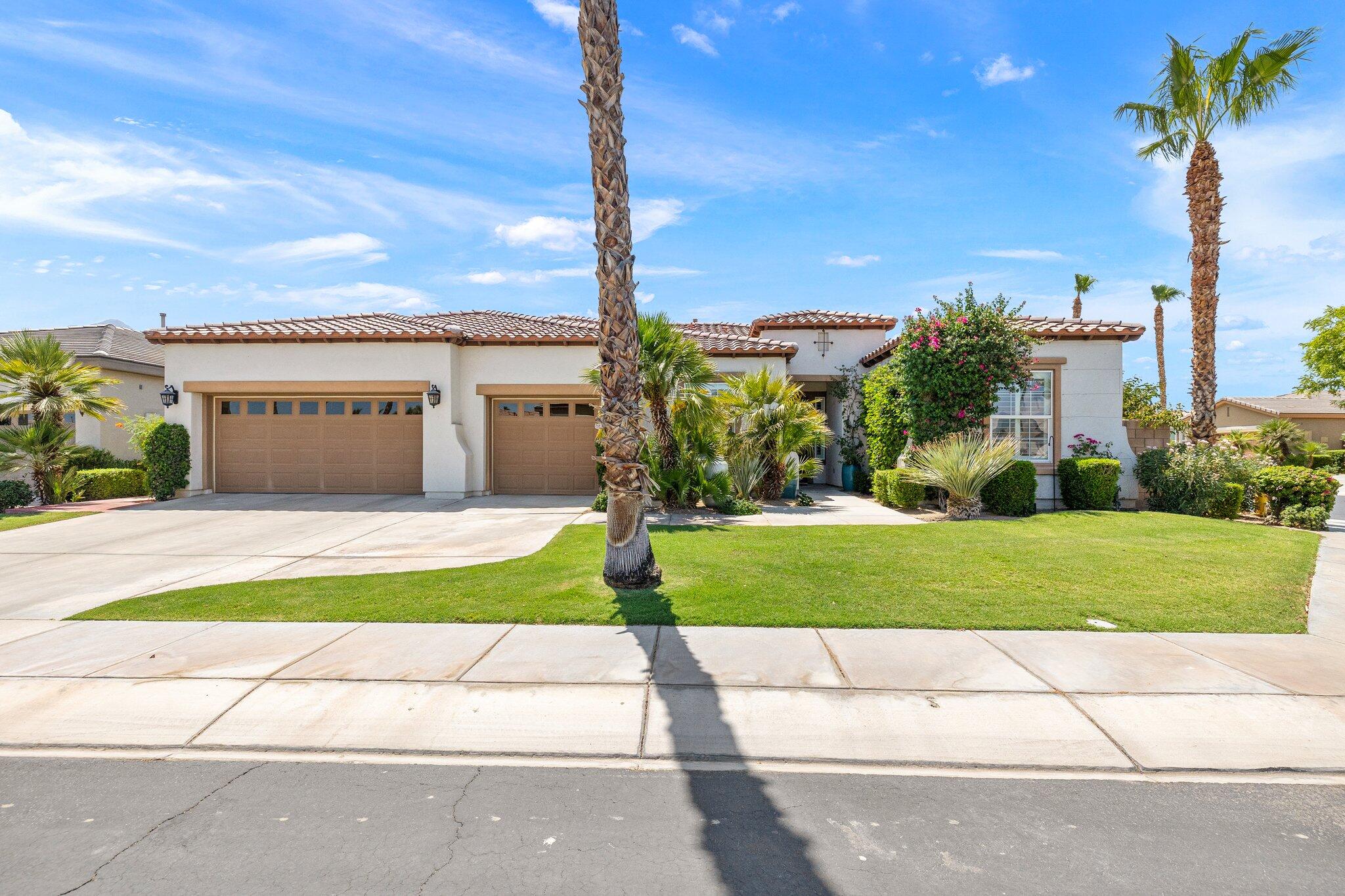 61185 Soaptree Drive La Quinta, CA 92253 - Photo 50 of 51 a front view of a house with a yard and potted plants