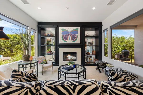 a living room with furniture and a floor to ceiling window