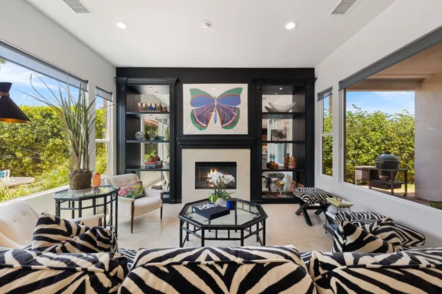 a living room with furniture and a floor to ceiling window