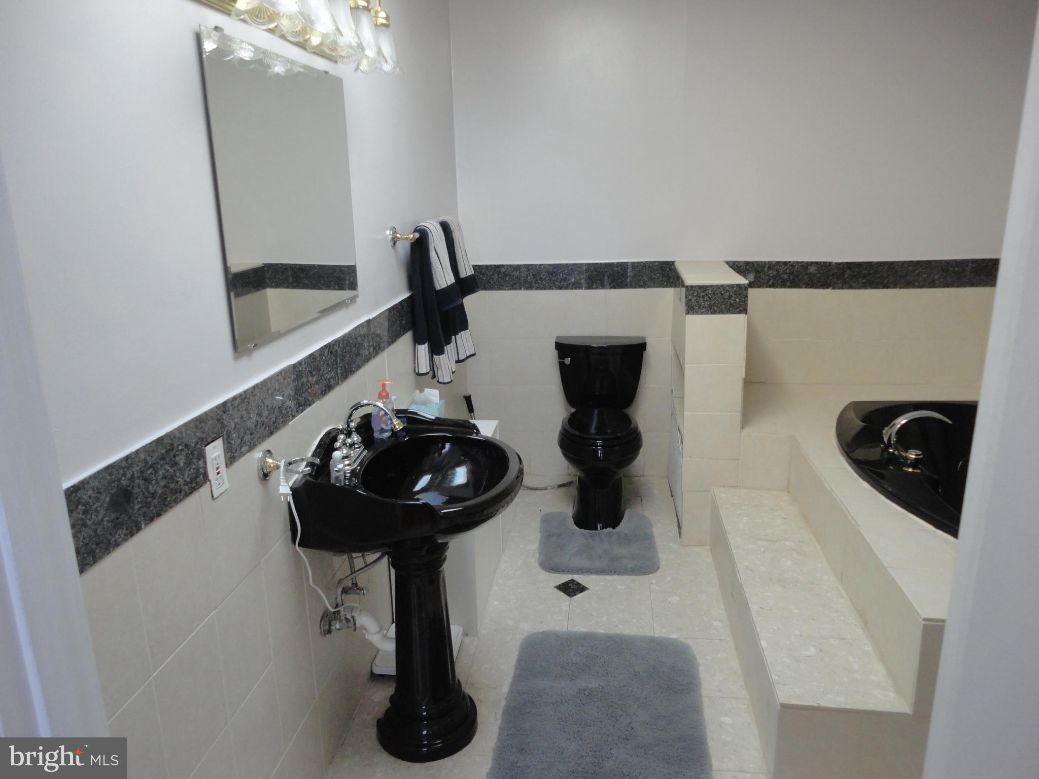 7818 Harbor Road Pasadena, MD 21122 - Photo 16 of 23 MBR Bathroom with Whirlpool Tub & Shower