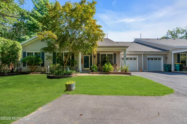 a front view of a house with a garden and patio