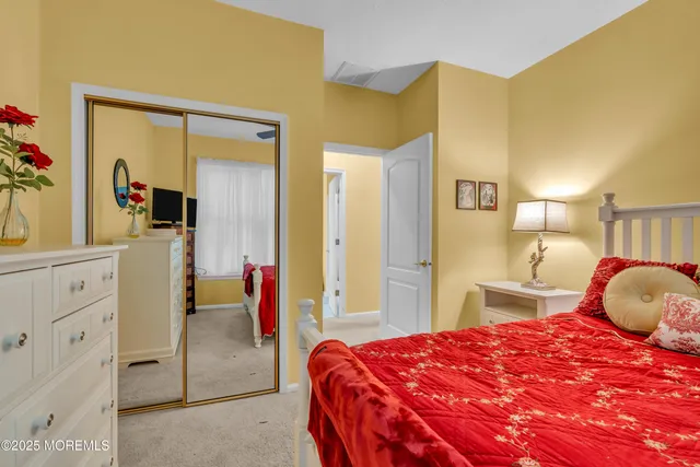 a bedroom with a bed and a mirror