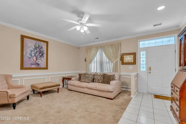a living room with furniture and a painting on the wall