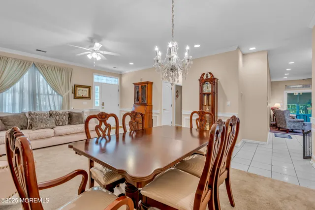 a view of a dining room with furniture and chandelier