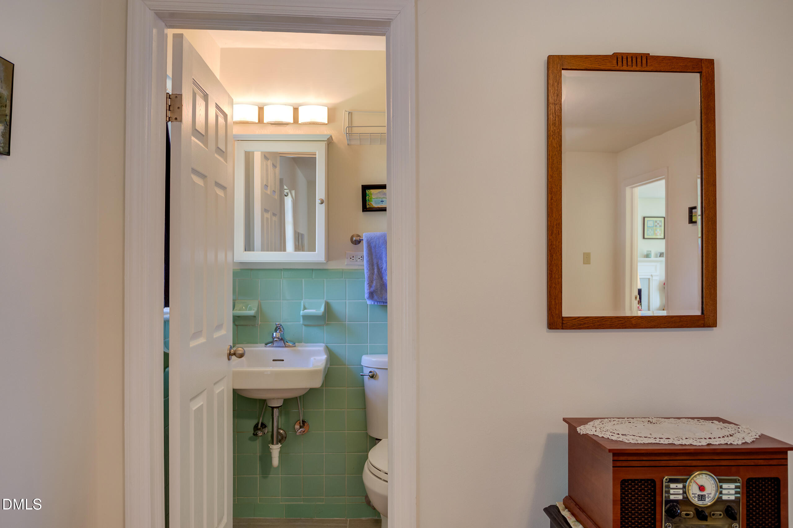 1102 Horton Road Durham, NC 27704 - Photo 11 of 31 a bathroom with a sink a toilet and mirror