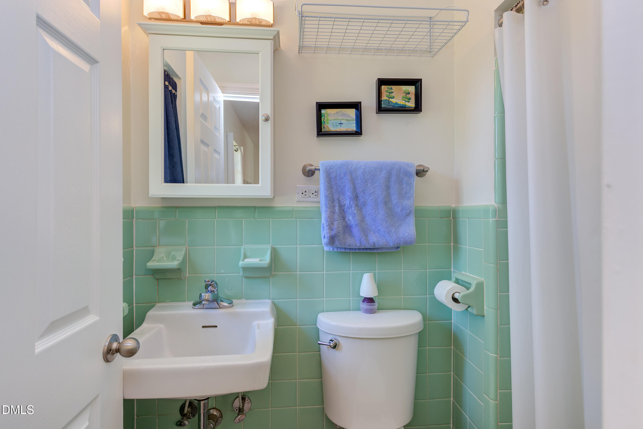 1102 Horton Road Durham, NC 27704 - Photo 12 of 31 a bathroom with a sink a toilet and a mirror