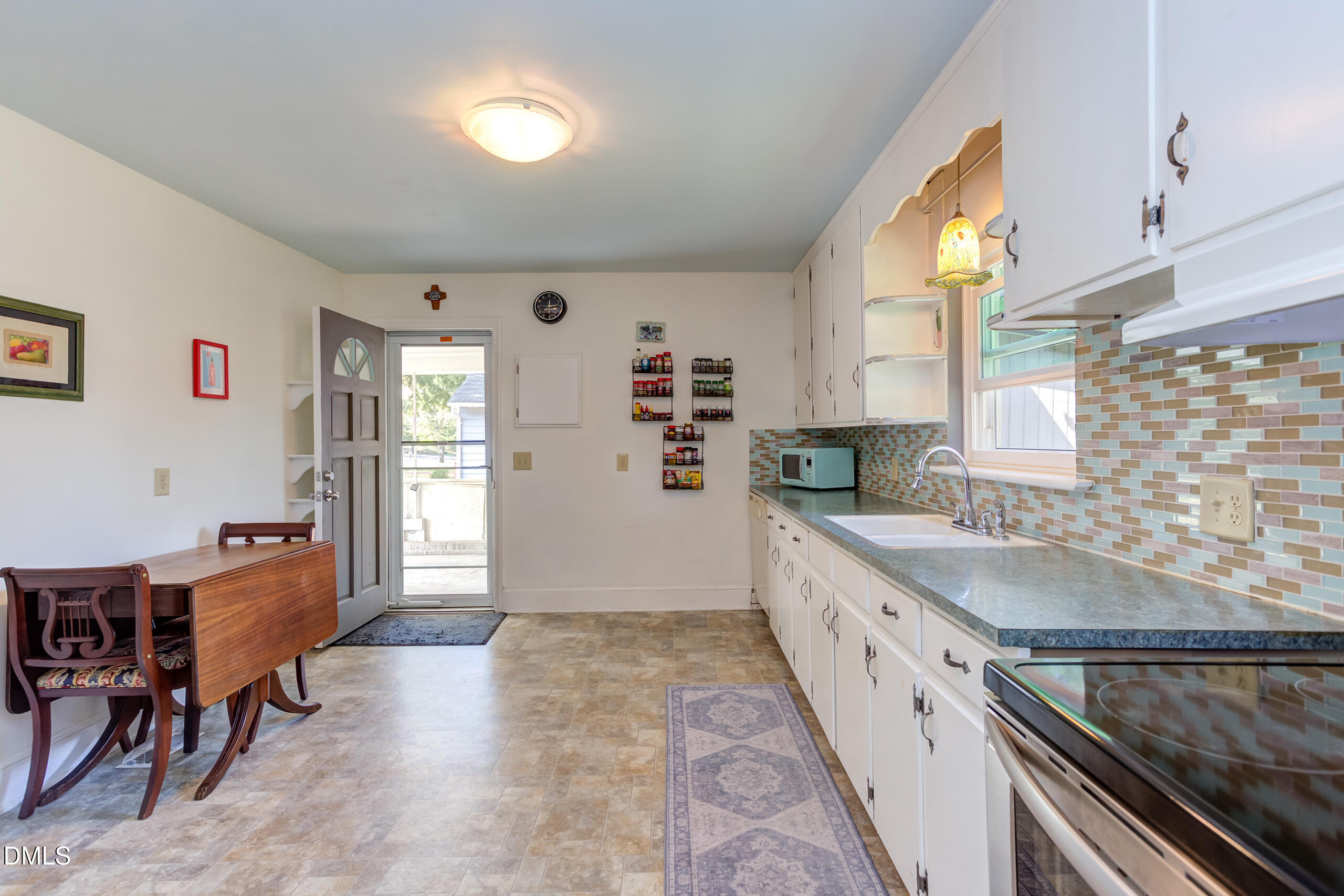 1102 Horton Road Durham, NC 27704 - Photo 13 of 31 a kitchen with granite countertop a sink and cabinets