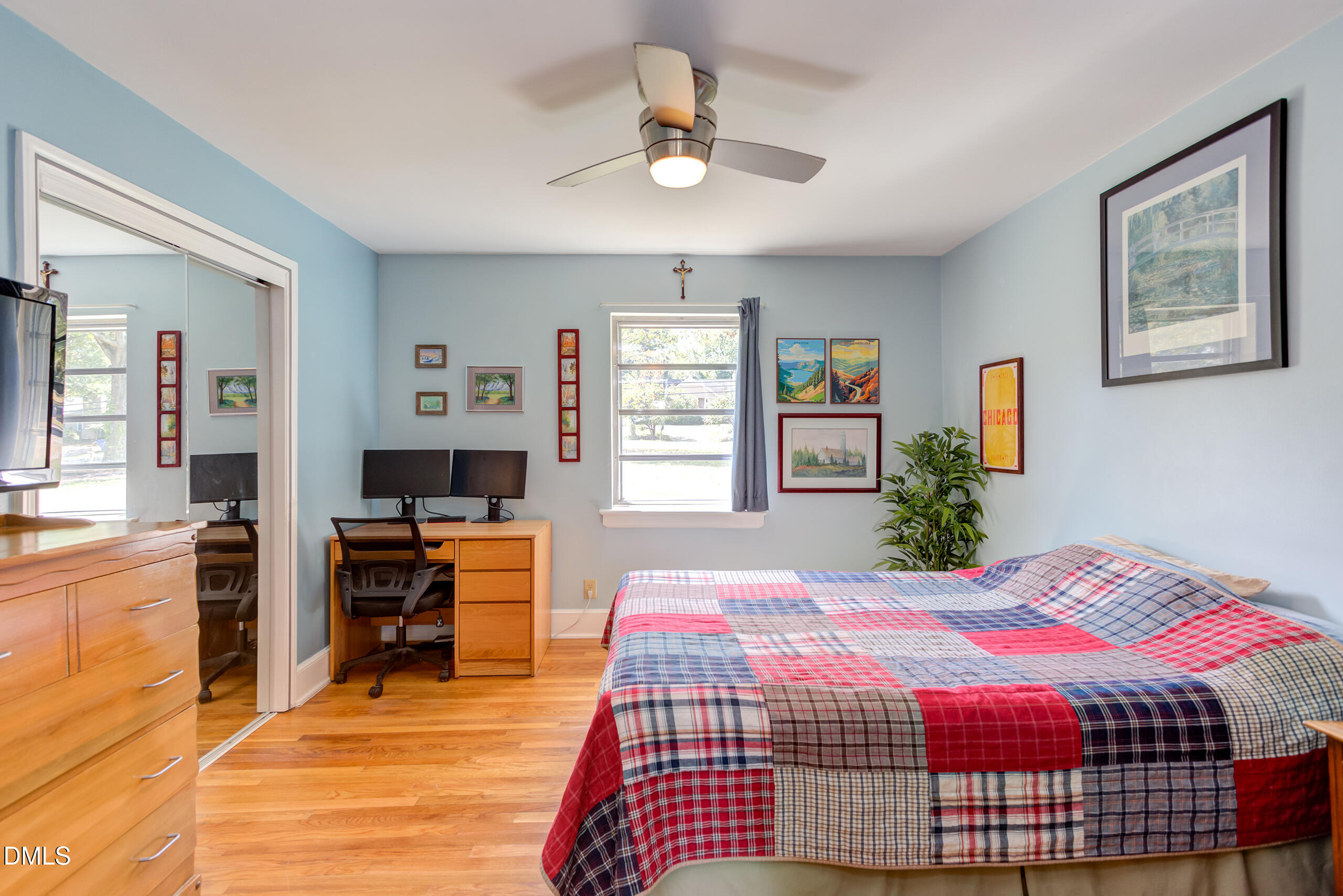 1102 Horton Road Durham, NC 27704 - Photo 17 of 31 a bedroom with a bed and wooden floor