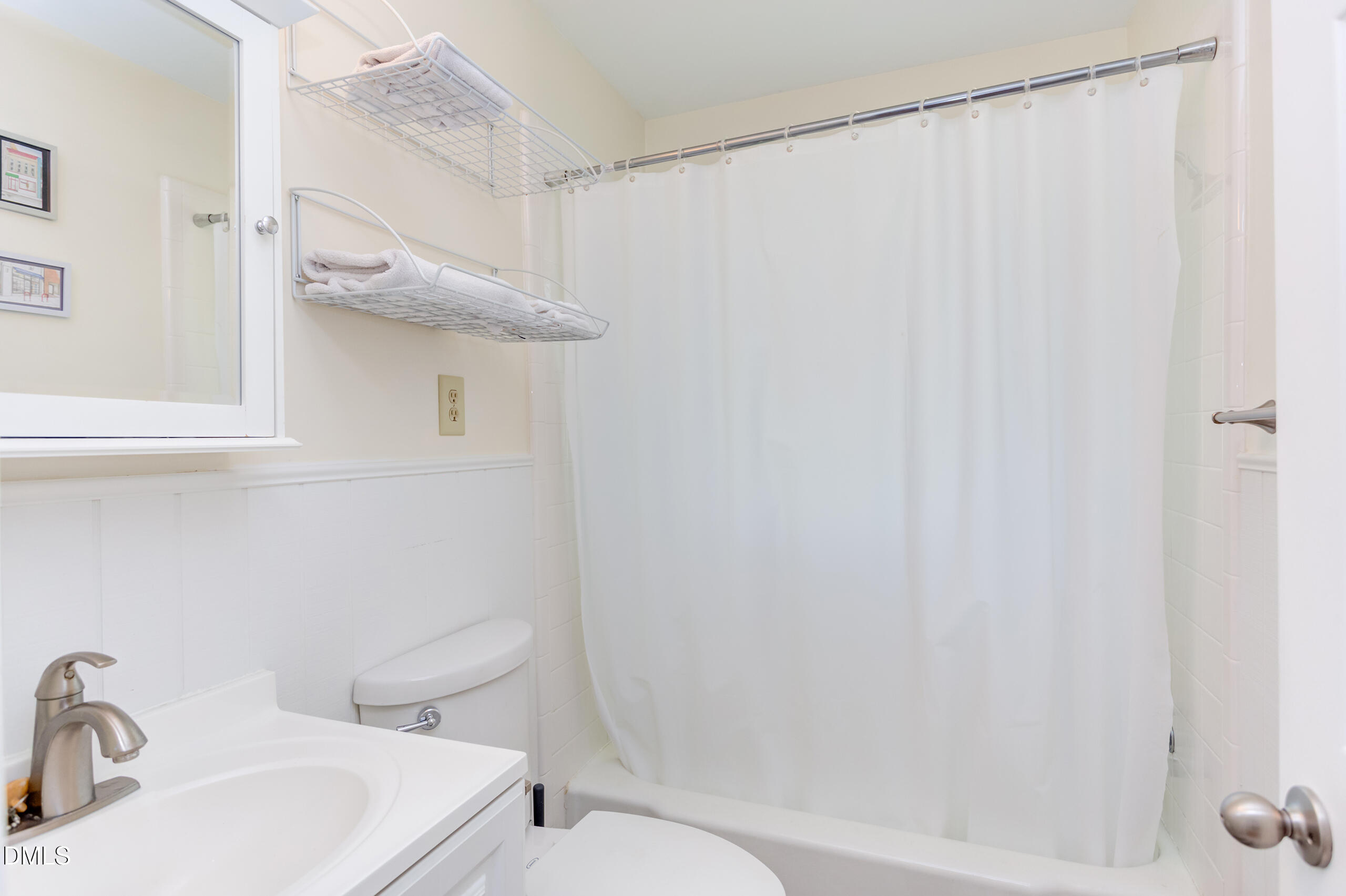 1102 Horton Road Durham, NC 27704 - Photo 19 of 31 a bathroom with a sink a toilet and shower