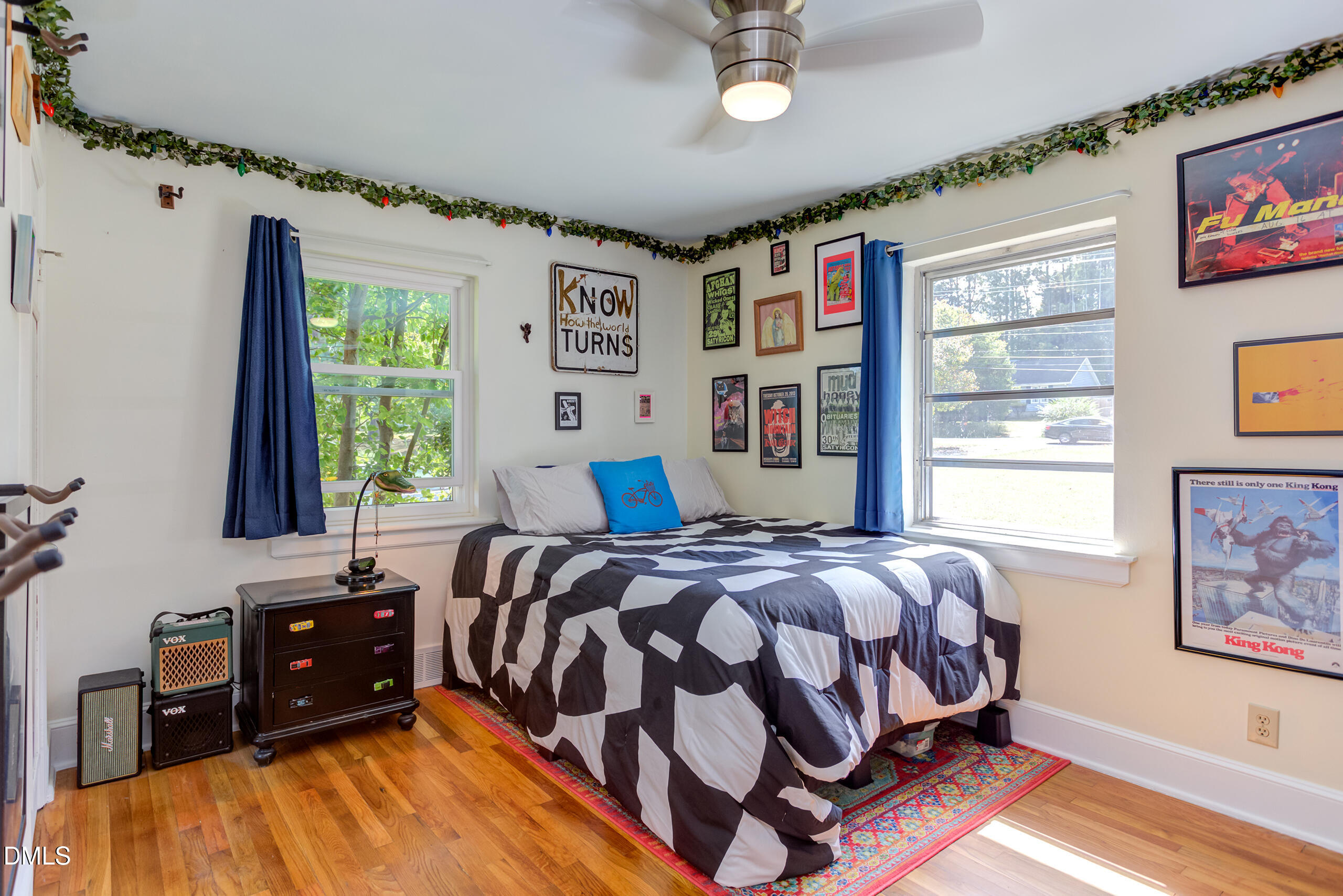 1102 Horton Road Durham, NC 27704 - Photo 20 of 31 a bedroom with a bed next to a window with a bookshelf