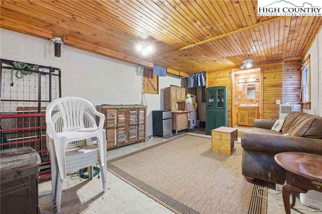 476 Moon Ridge Road Crumpler, NC 28617 - Photo 23 of 35 a living room with furniture a flat screen tv and a table