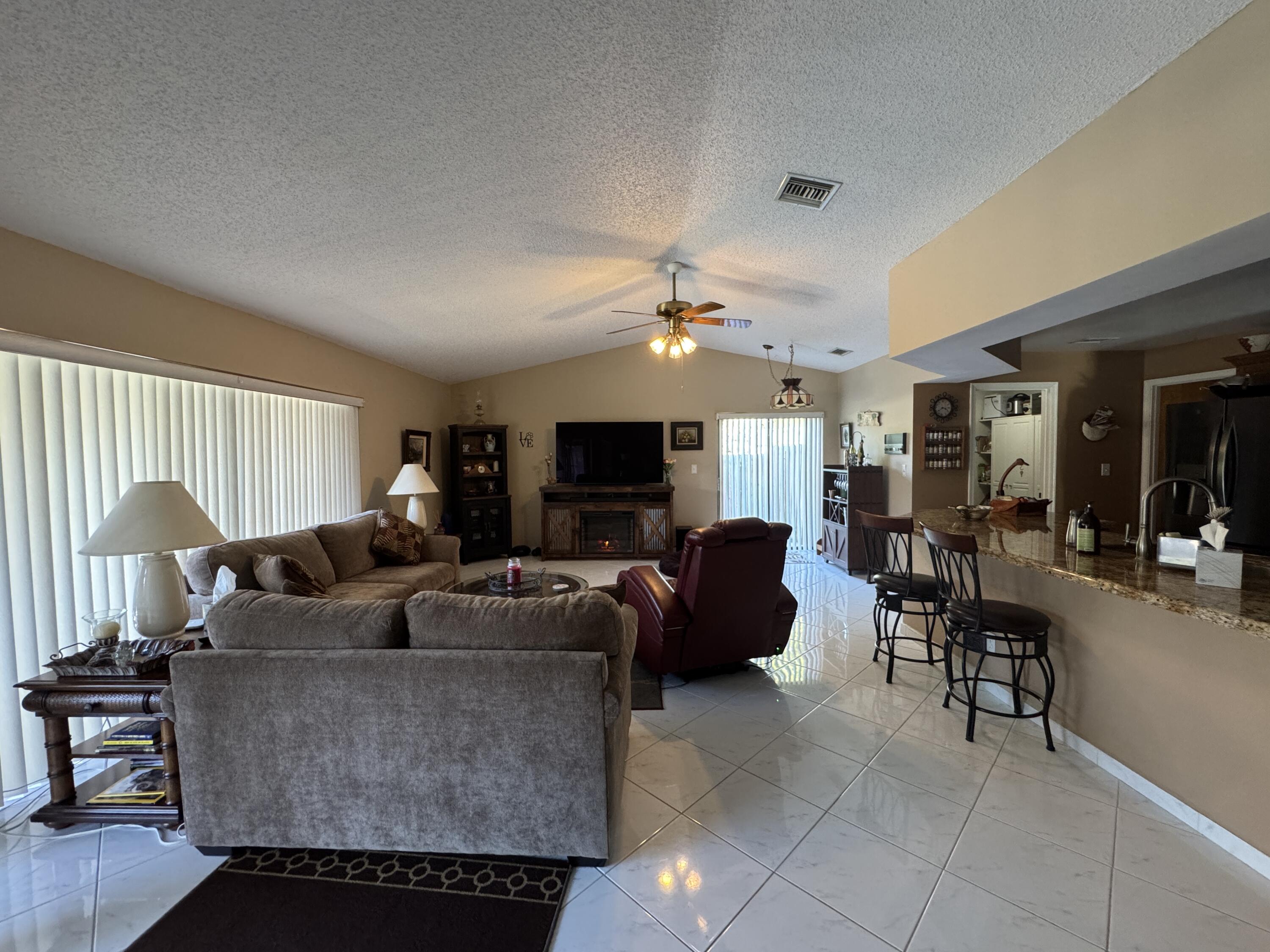 21149 Shady Vista Lane Boca Raton, FL 33428 - Photo 16 of 32 a living room with furniture and a flat screen tv