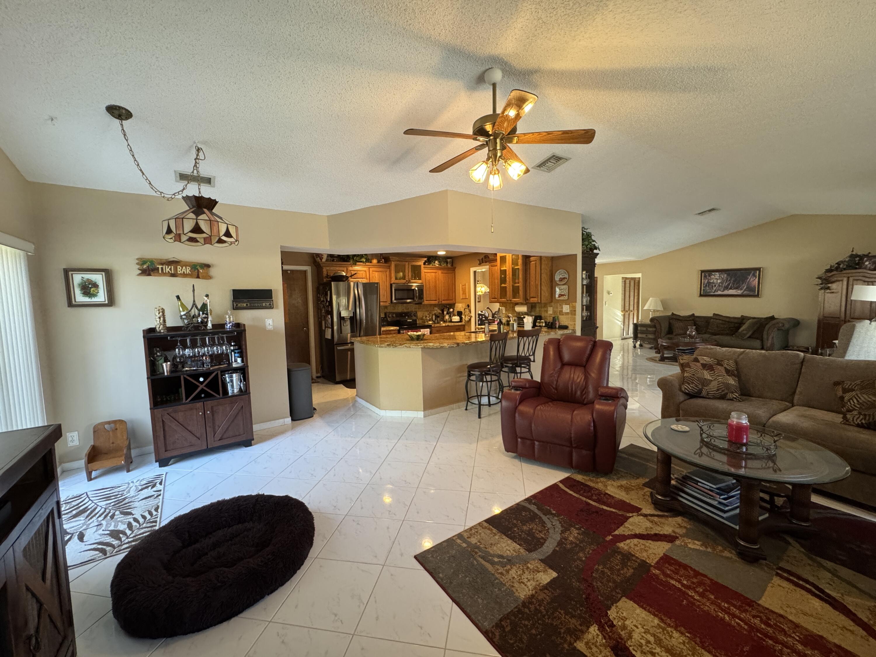 21149 Shady Vista Lane Boca Raton, FL 33428 - Photo 17 of 32 a living room with furniture a rug and a chandelier