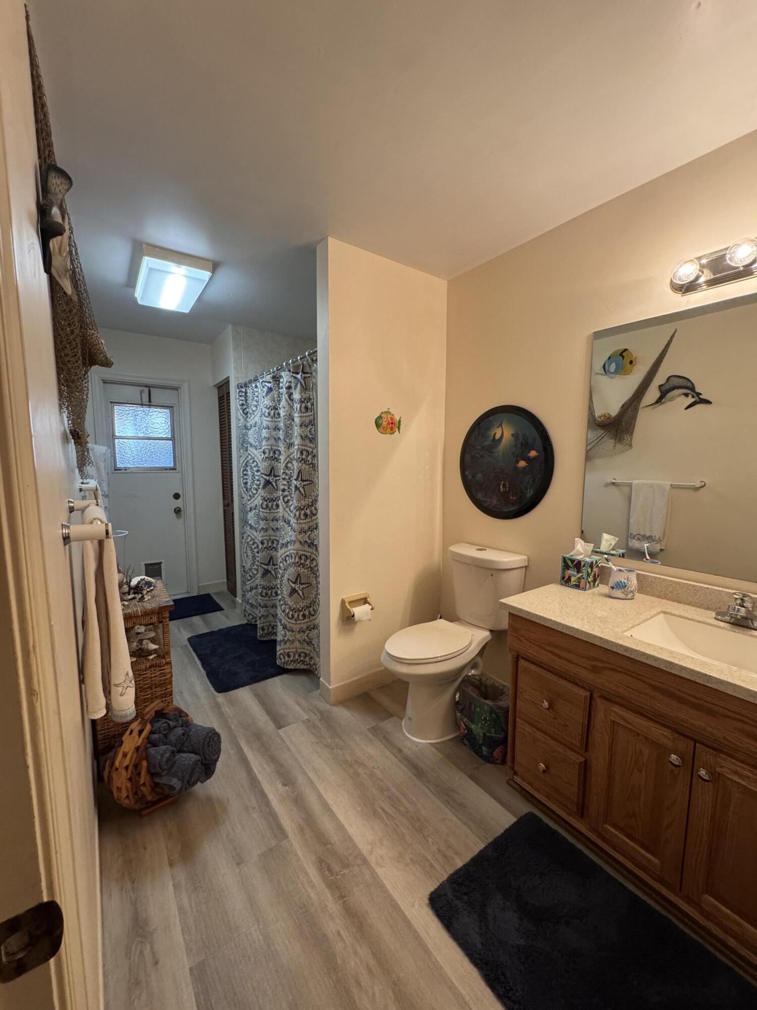 21149 Shady Vista Lane Boca Raton, FL 33428 - Photo 20 of 32 a spacious bathroom with a double vanity sink a toilet and a mirror