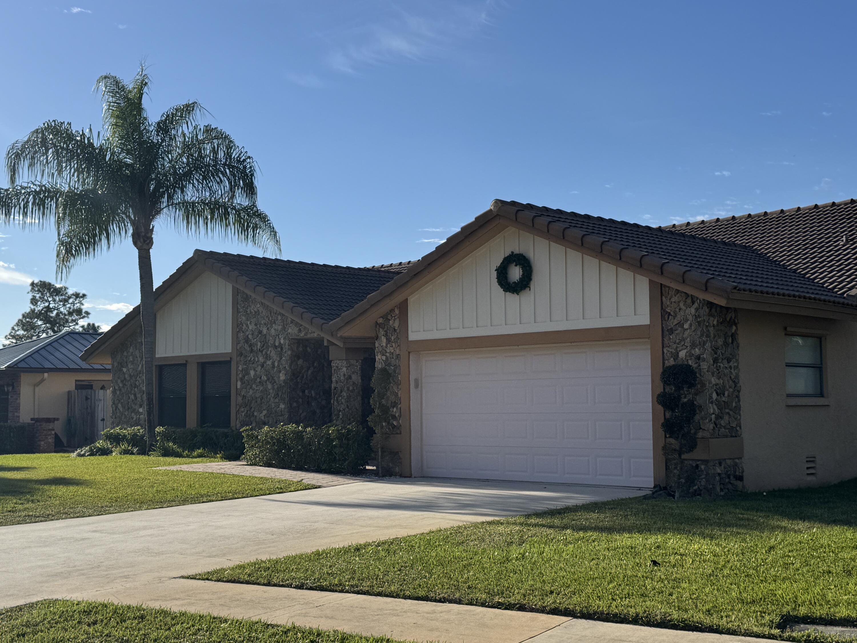 21149 Shady Vista Lane Boca Raton, FL 33428 - Photo 2 of 32 a front view of house with yard and garage