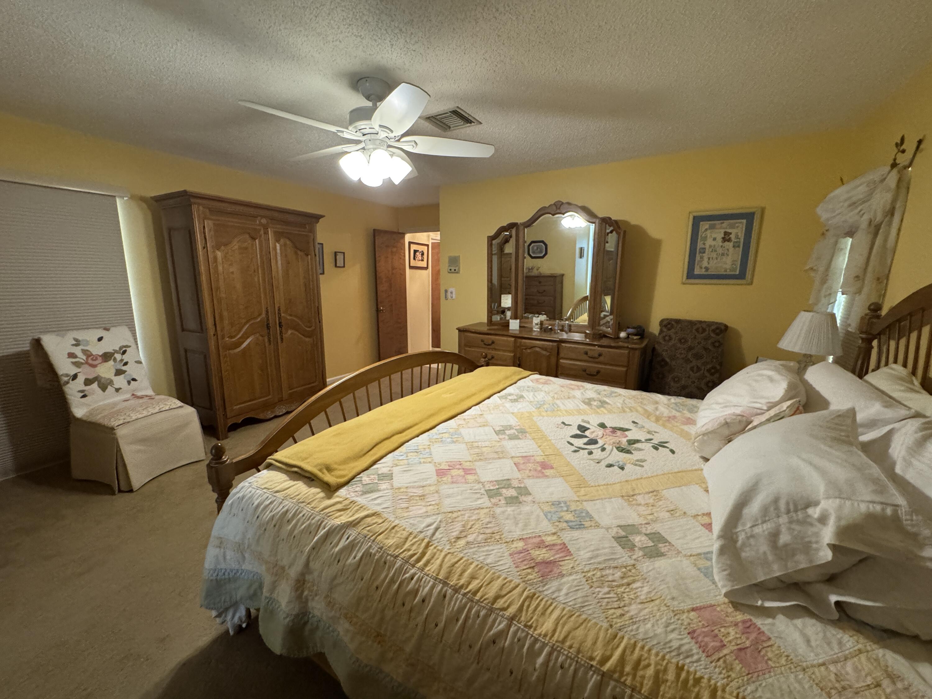21149 Shady Vista Lane Boca Raton, FL 33428 - Photo 23 of 32 a bedroom with a large bed and a chandelier