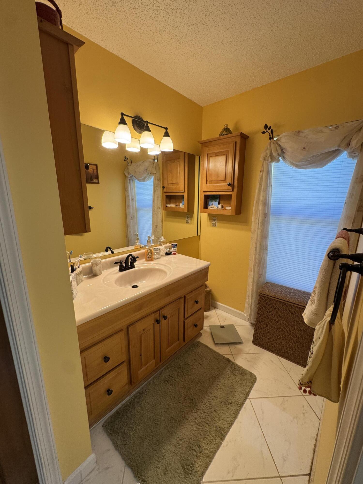 21149 Shady Vista Lane Boca Raton, FL 33428 - Photo 24 of 32 a spacious bathroom with a double vanity sink and a mirror