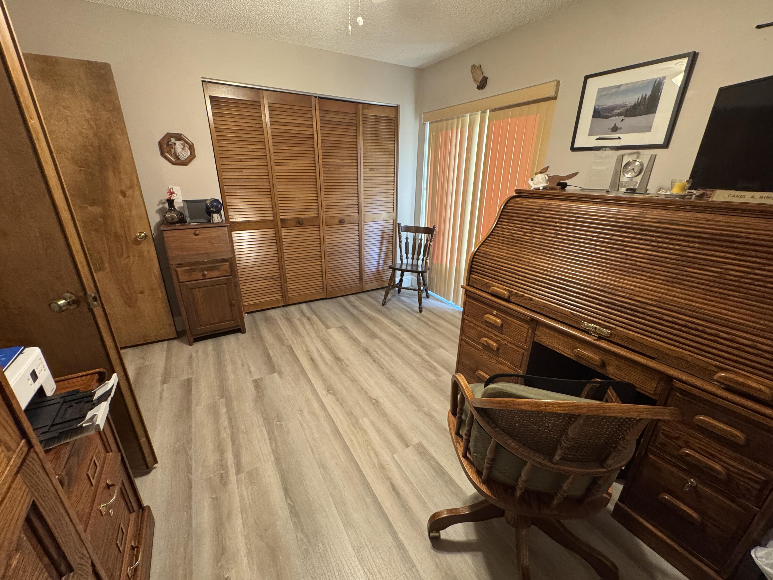 21149 Shady Vista Lane Boca Raton, FL 33428 - Photo 28 of 32 a bedroom with a bed and wooden floor