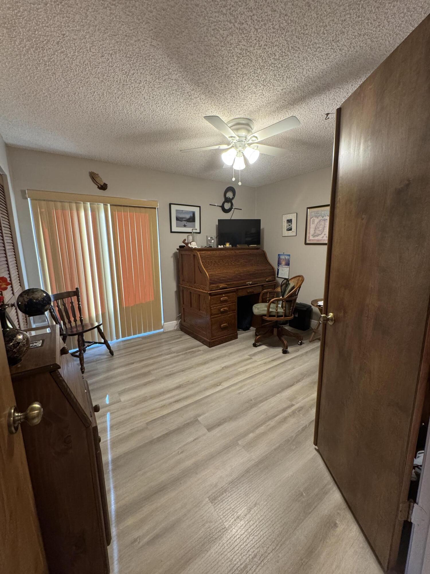 21149 Shady Vista Lane Boca Raton, FL 33428 - Photo 29 of 32 a bedroom with a bed and wooden floor