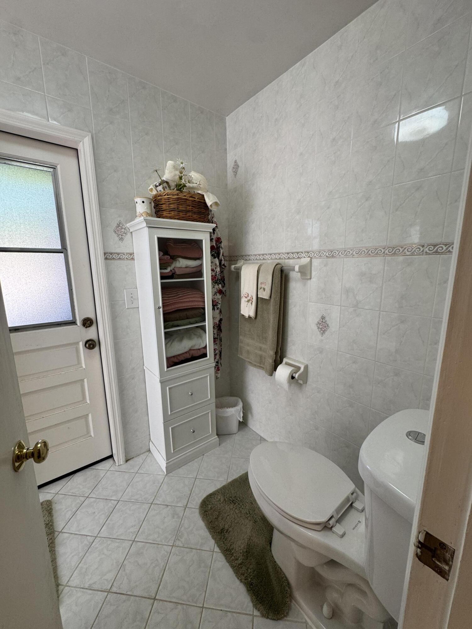 21149 Shady Vista Lane Boca Raton, FL 33428 - Photo 30 of 32 a bathroom with a toilet and a shower