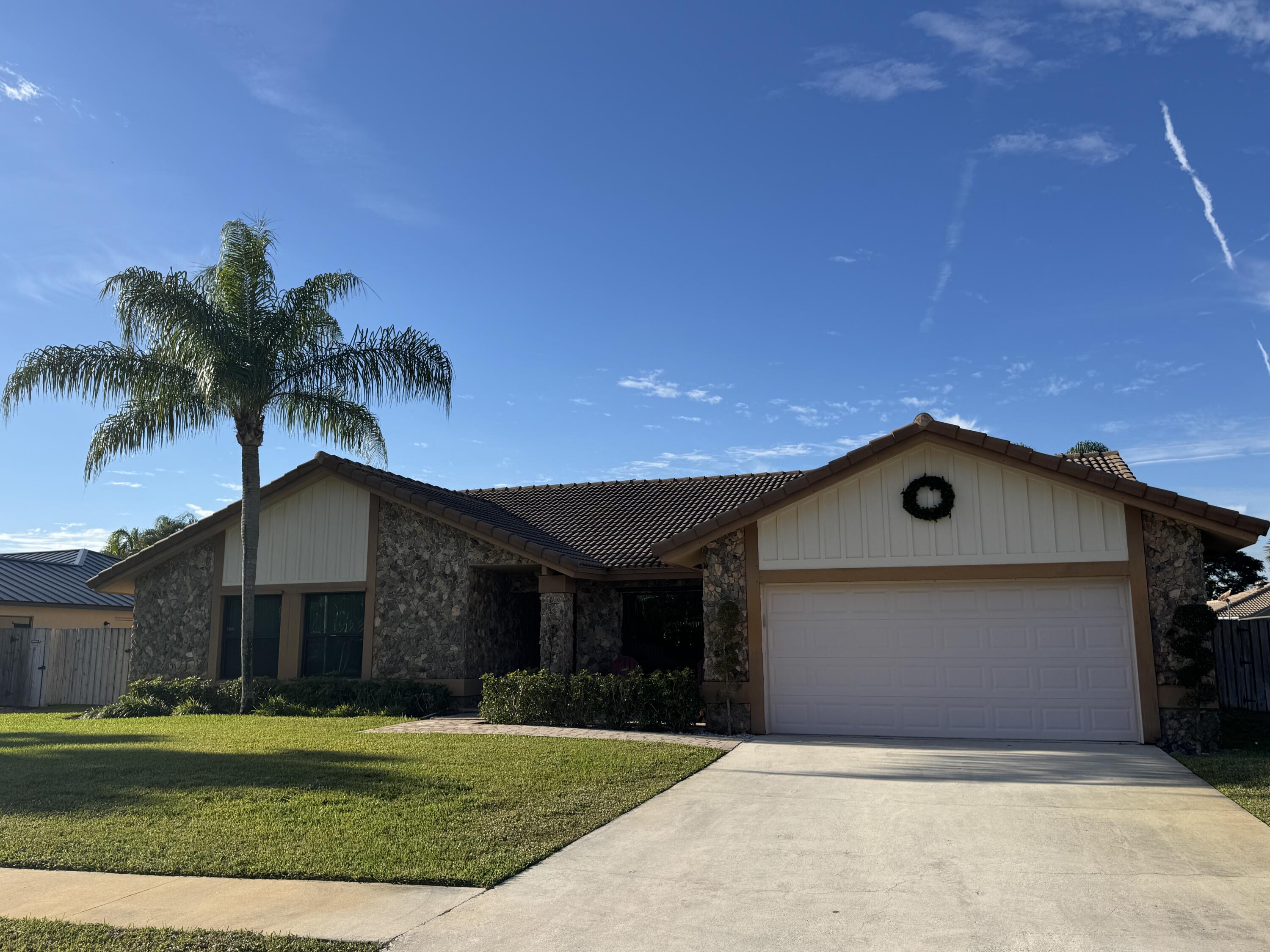 21149 Shady Vista Lane Boca Raton, FL 33428 - Photo 3 of 32 a front view of a house with a garden