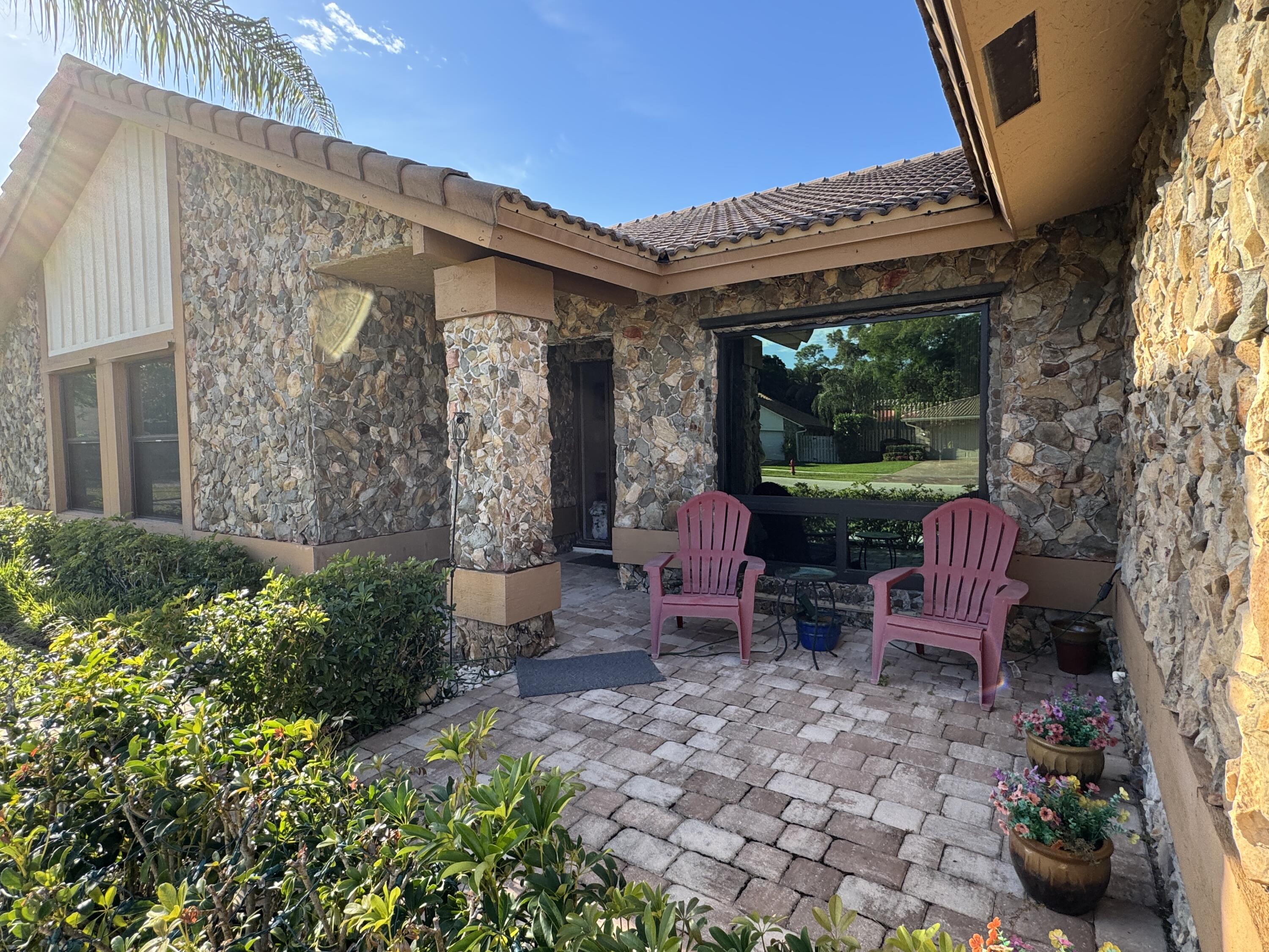 21149 Shady Vista Lane Boca Raton, FL 33428 - Photo 4 of 32 a view of a chair and table in backyard of the house