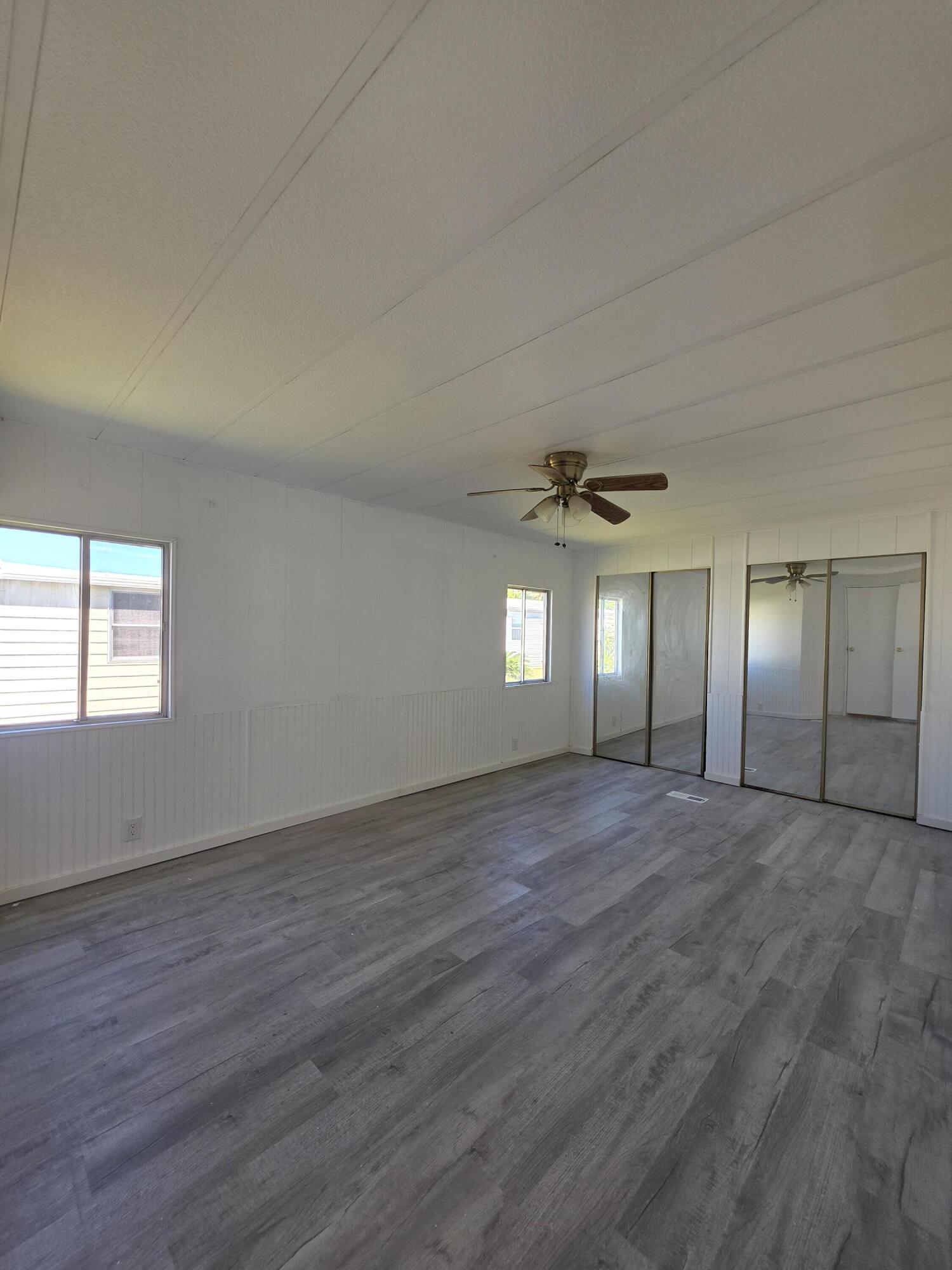 8 Del Sol Port St. Lucie, FL 34952 - Photo 14 of 26 an empty room with wooden floor and windows