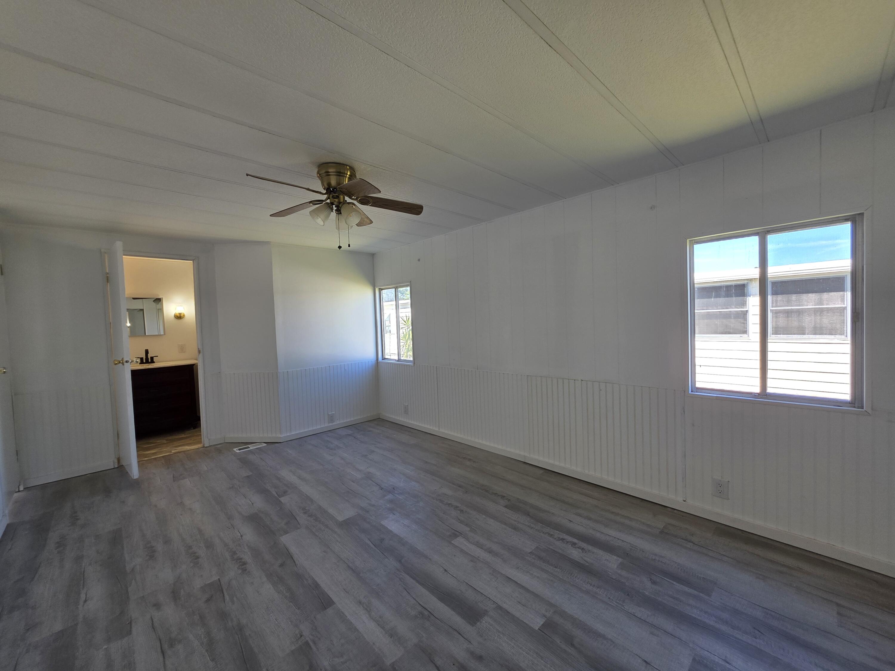 8 Del Sol Port St. Lucie, FL 34952 - Photo 15 of 26 an empty room that has a window and wooden floor