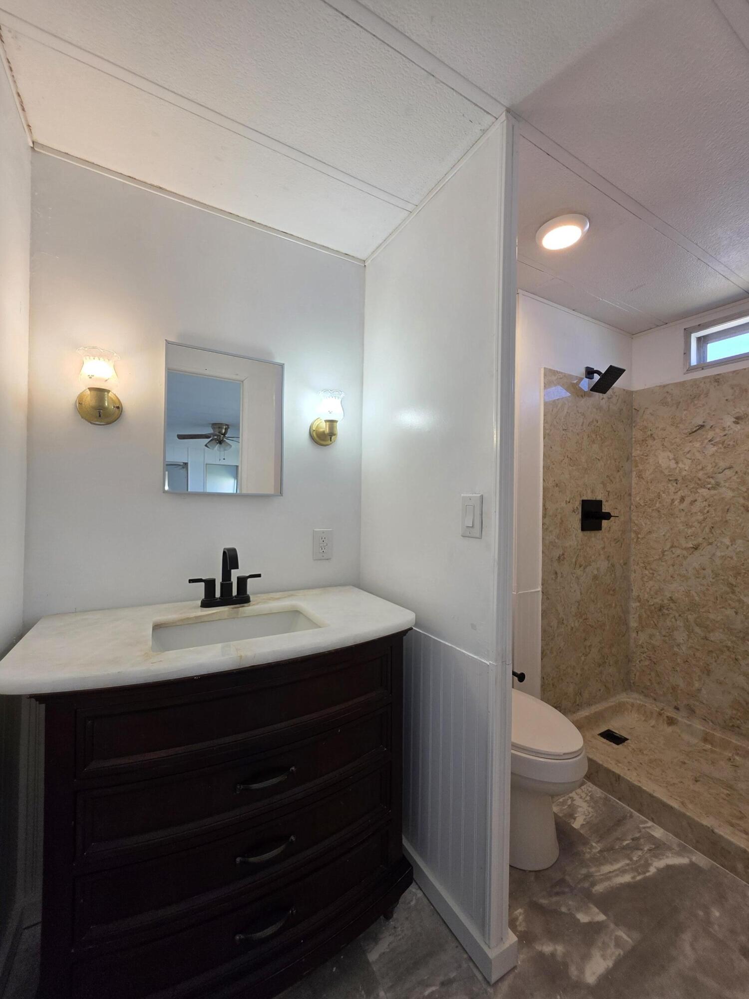 8 Del Sol Port St. Lucie, FL 34952 - Photo 17 of 26 a bathroom with a sink a toilet and shower