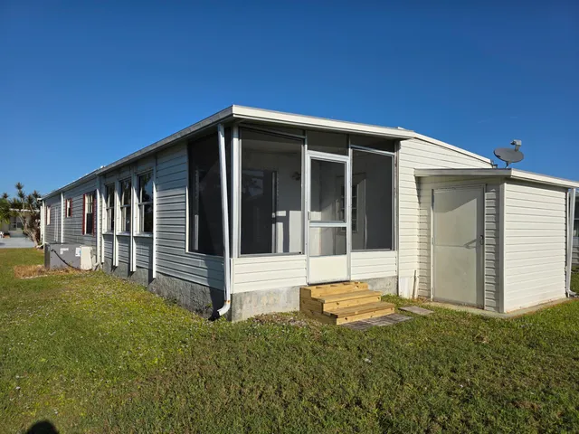 a view of house with backyard