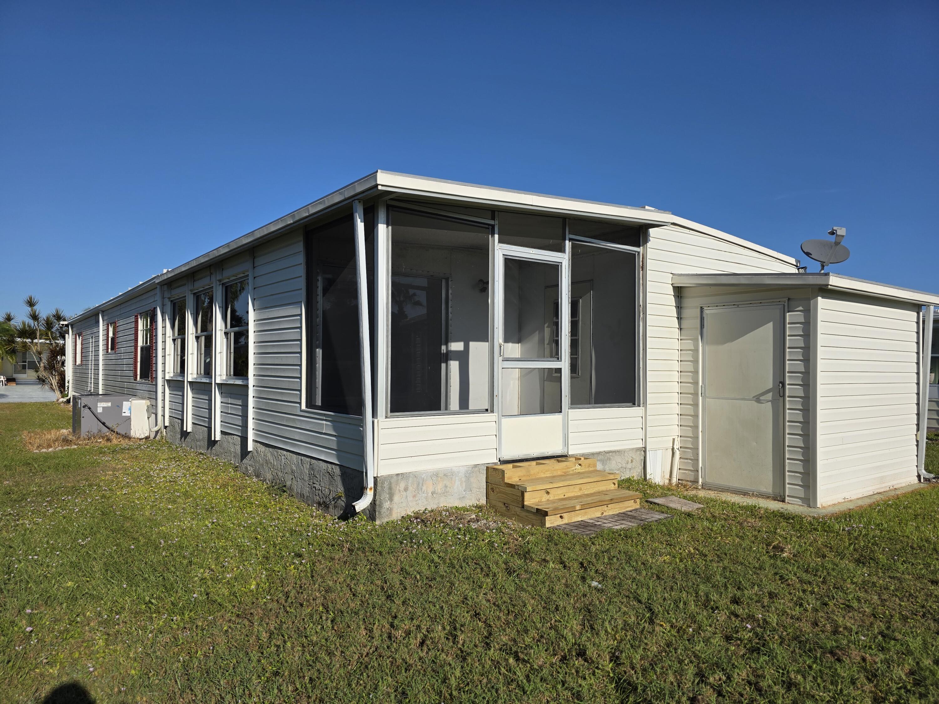 8 Del Sol Port St. Lucie, FL 34952 - Photo 2 of 26 a view of house with backyard