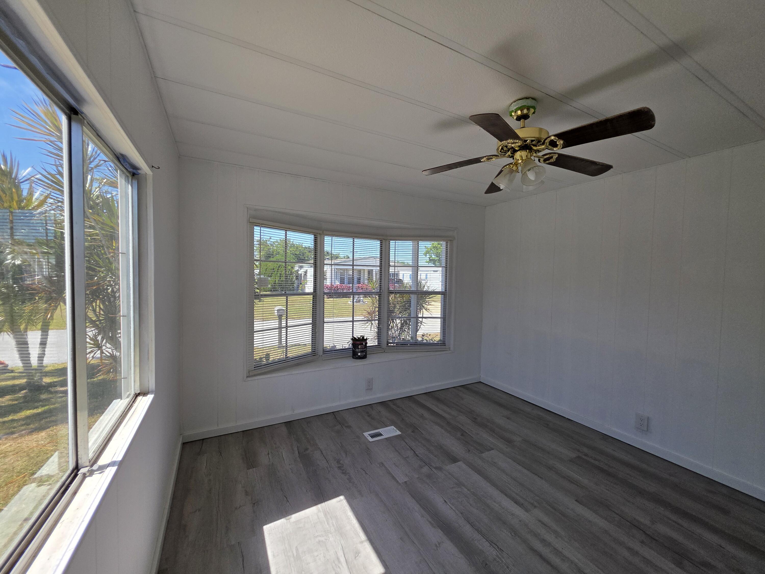 8 Del Sol Port St. Lucie, FL 34952 - Photo 21 of 26 wooden floor in an empty room with a window