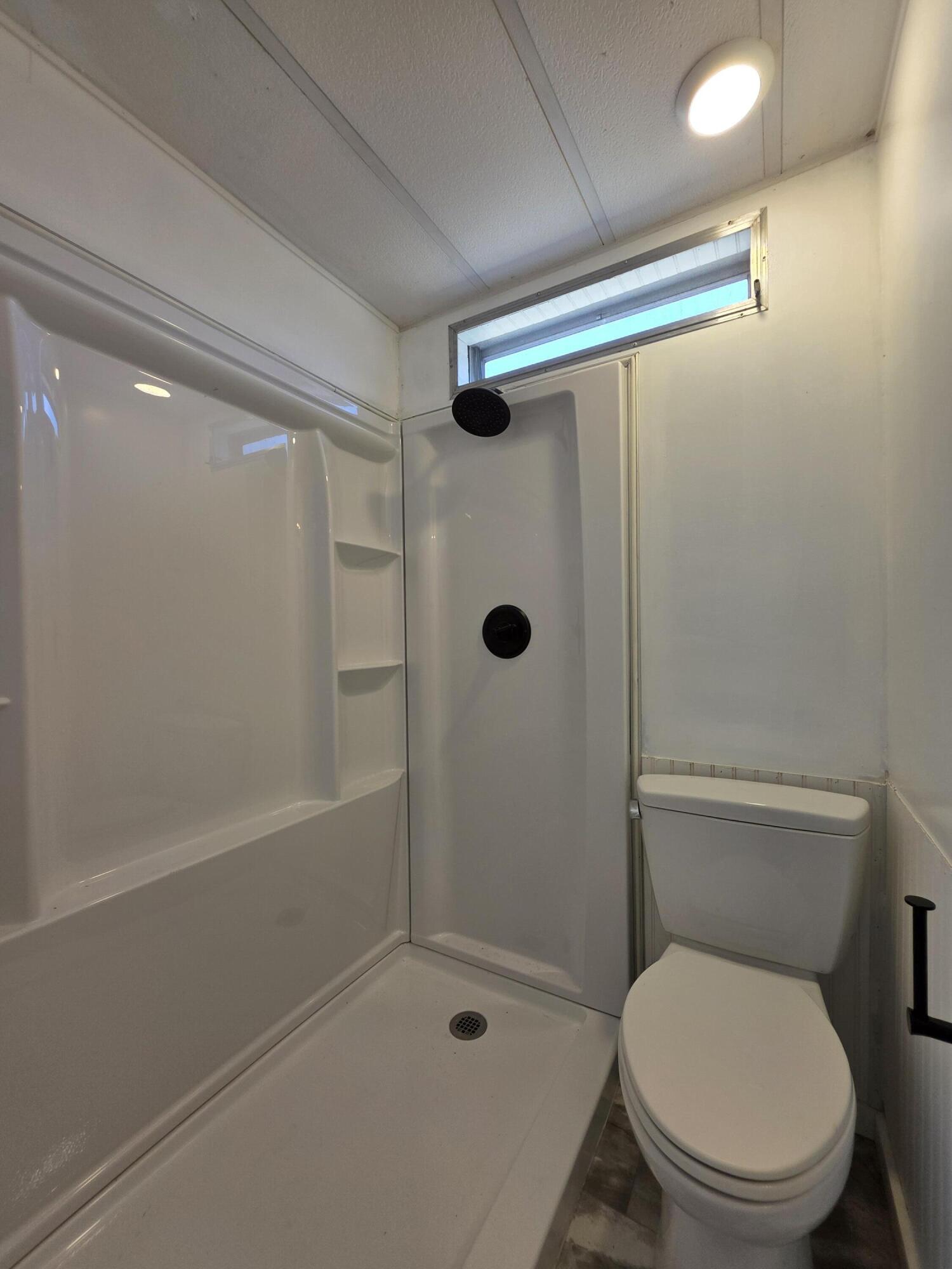 8 Del Sol Port St. Lucie, FL 34952 - Photo 23 of 26 a bathroom with a toilet and a shower