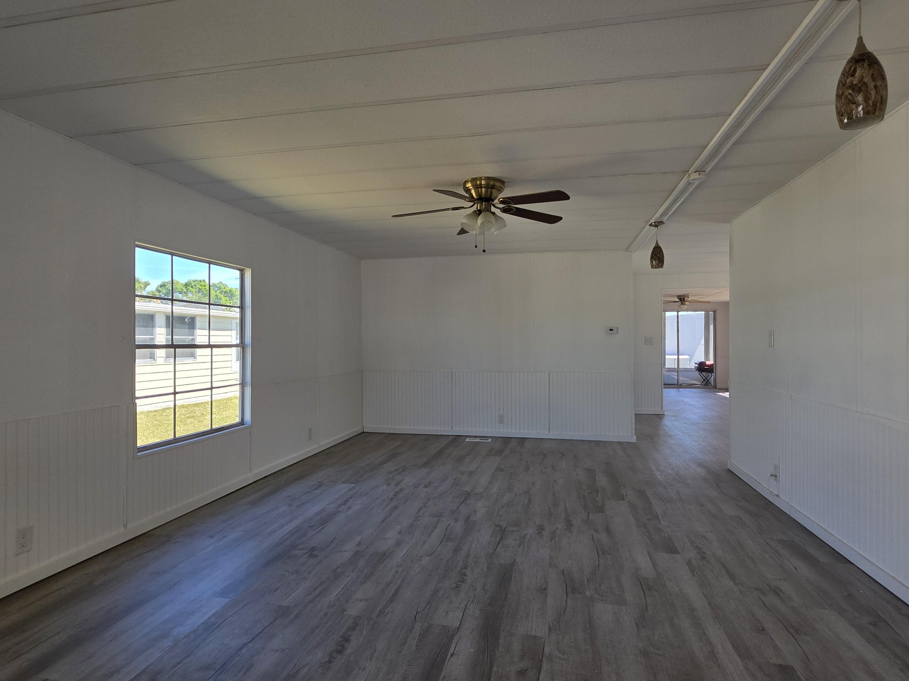 8 Del Sol Port St. Lucie, FL 34952 - Photo 4 of 26 wooden floor in an empty room with a window
