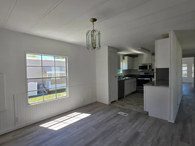 a kitchen with stainless steel appliances granite countertop a refrigerator and a stove top oven