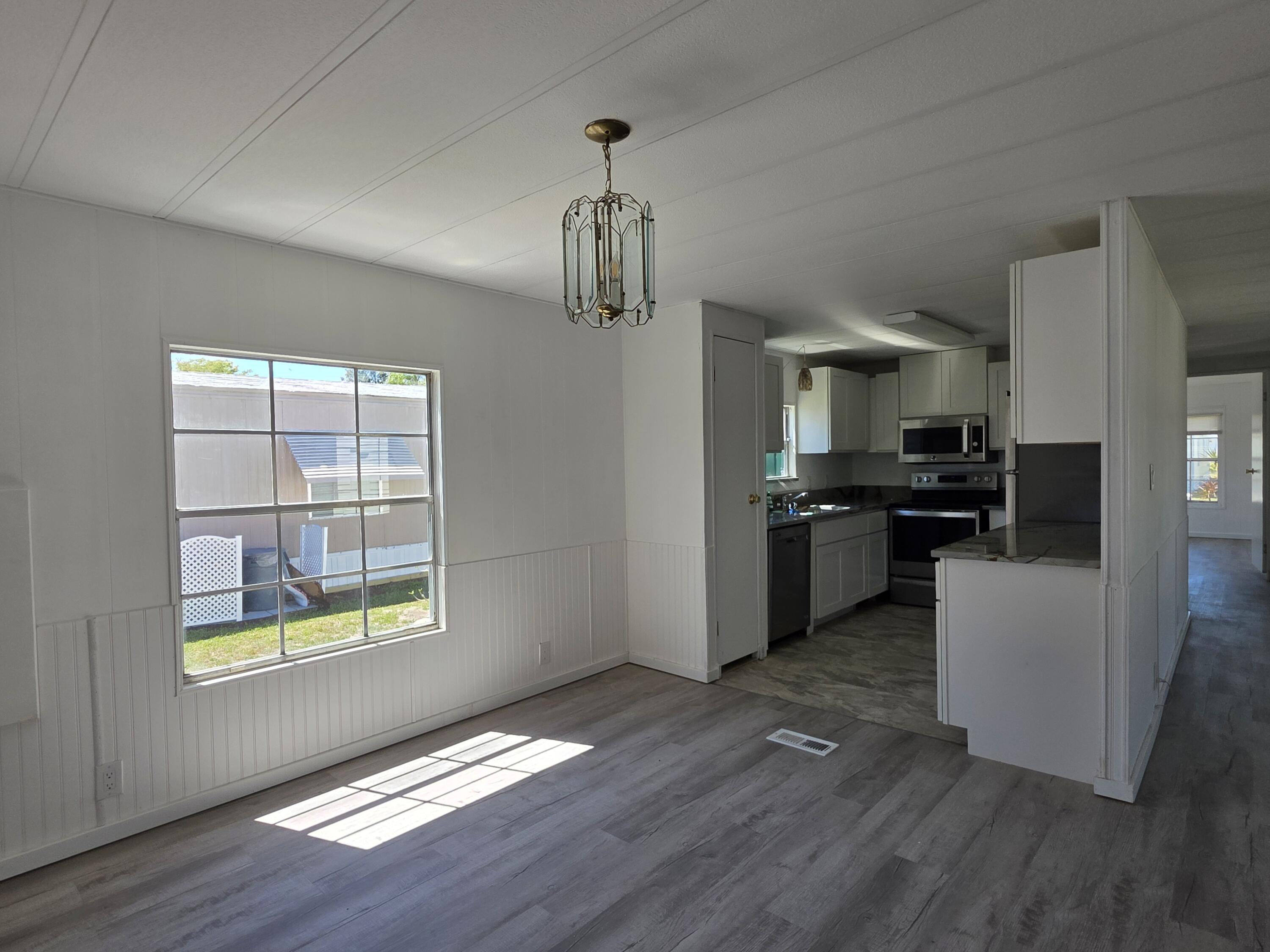 8 Del Sol Port St. Lucie, FL 34952 - Photo 10 of 26 a kitchen with stainless steel appliances granite countertop a refrigerator and a stove top oven