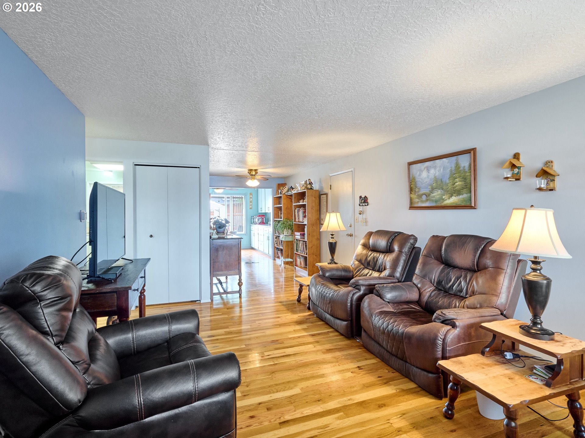 1215 Stanfield Road Woodburn, OR 97071 - Photo 3 of 29 a living room with furniture and a flat screen tv