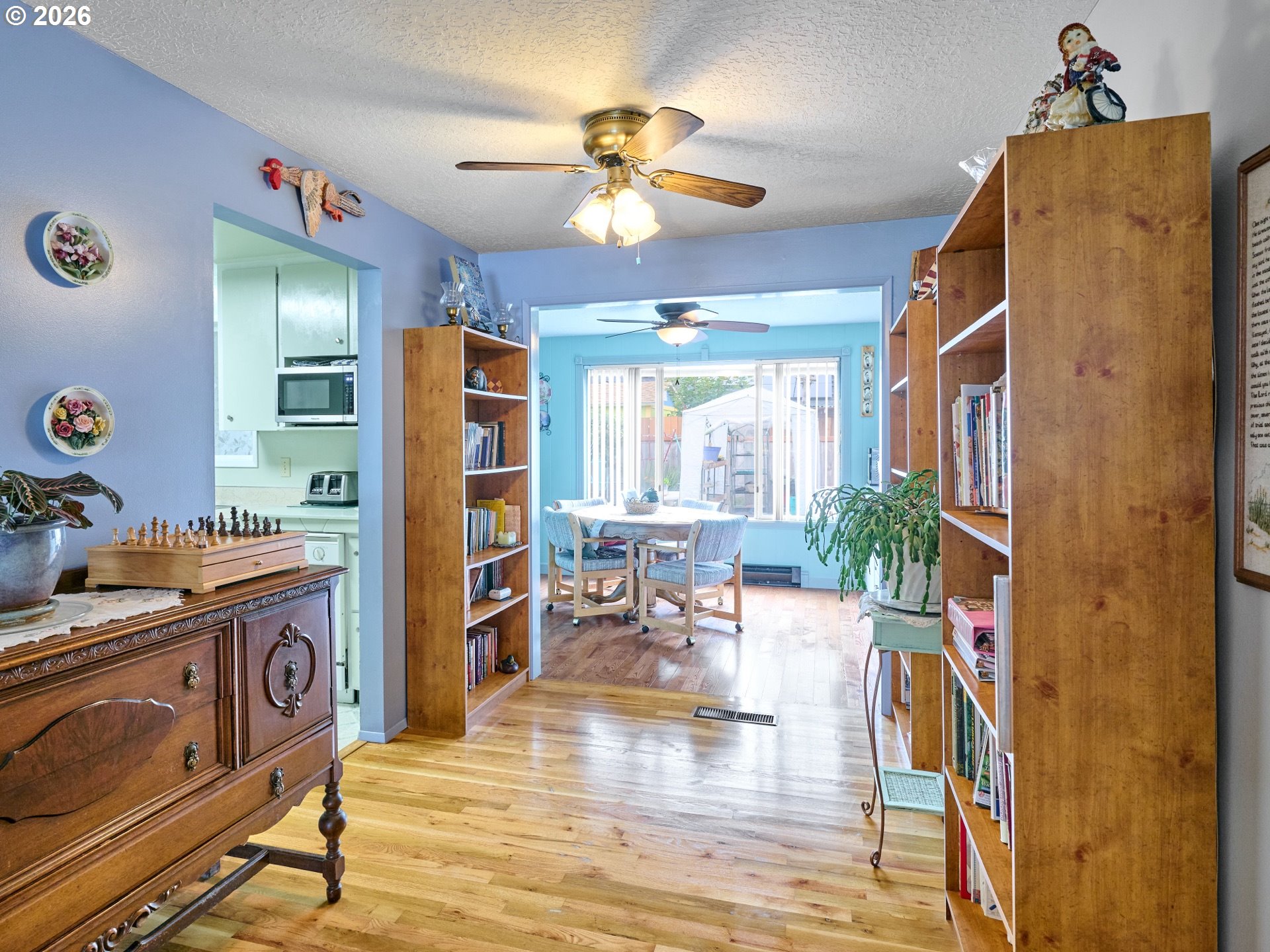 1215 Stanfield Road Woodburn, OR 97071 - Photo 5 of 29 a view of a livingroom with furniture hardwood floor and a ceiling fan