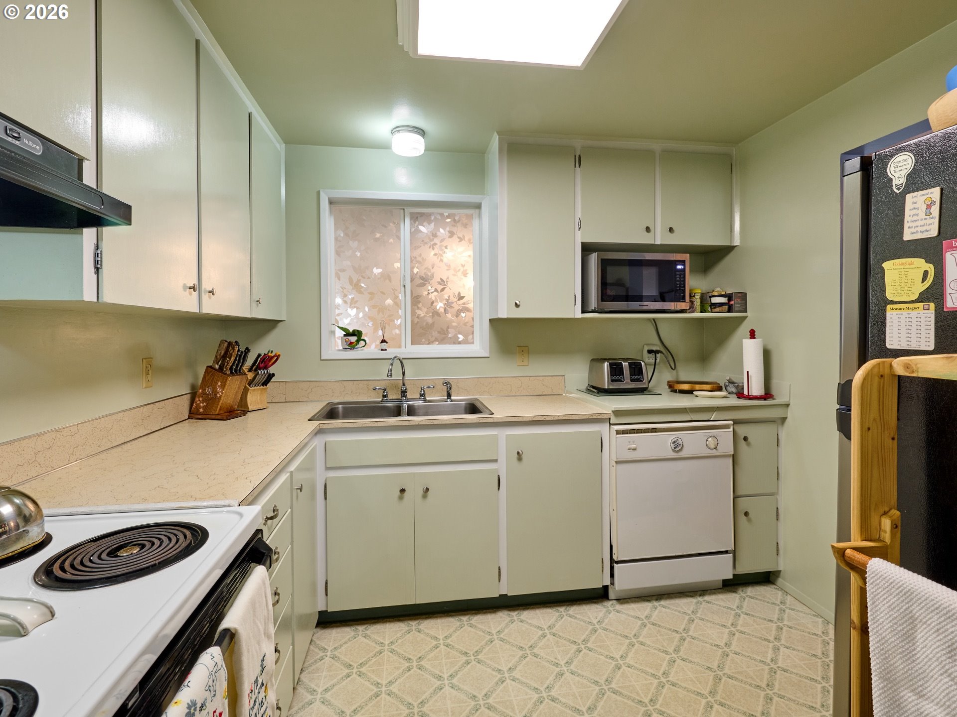 1215 Stanfield Road Woodburn, OR 97071 - Photo 7 of 29 a kitchen with a sink cabinets and window