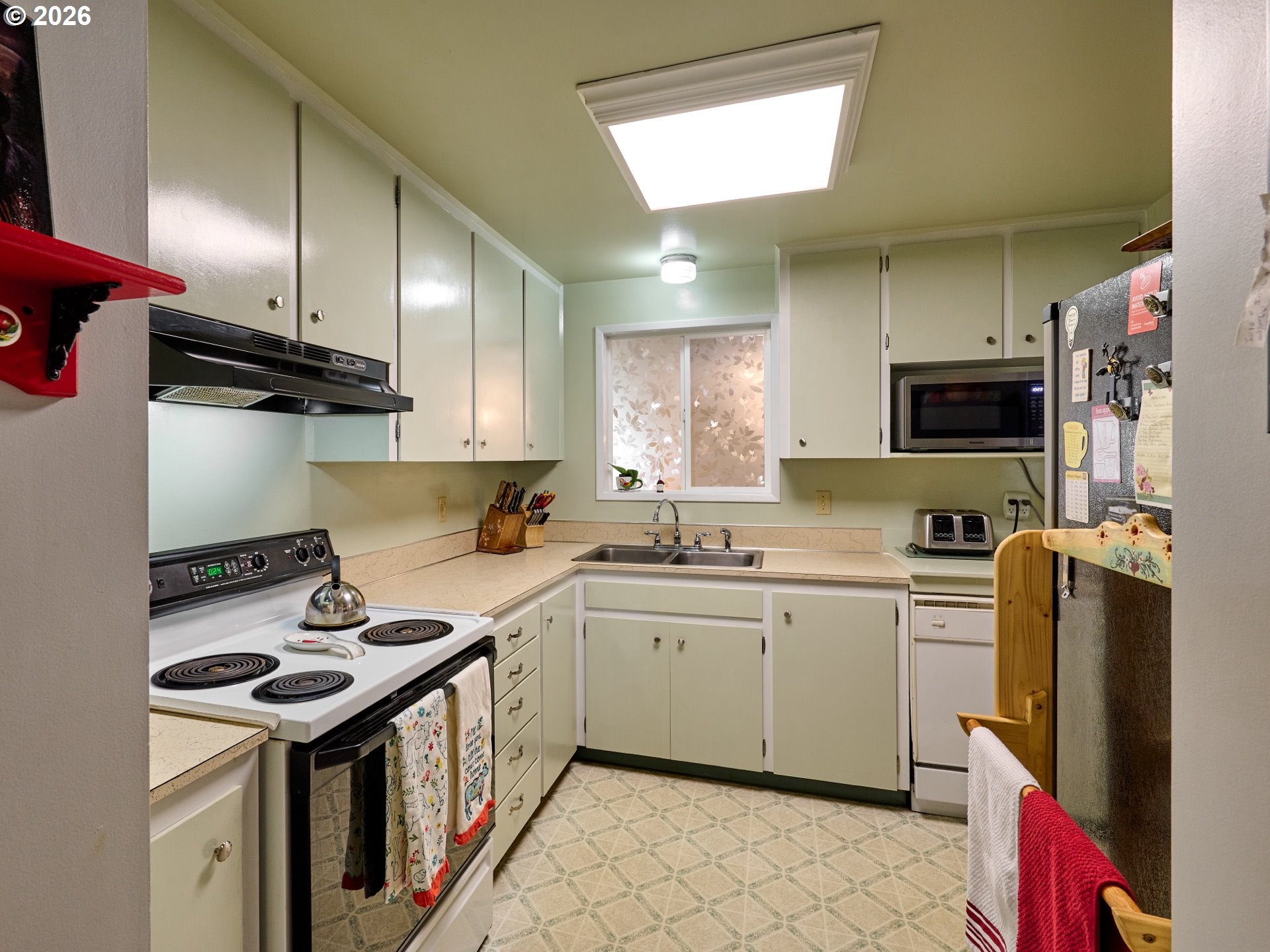 1215 Stanfield Road Woodburn, OR 97071 - Photo 8 of 29 a kitchen with stainless steel appliances a sink stove refrigerator and cabinets