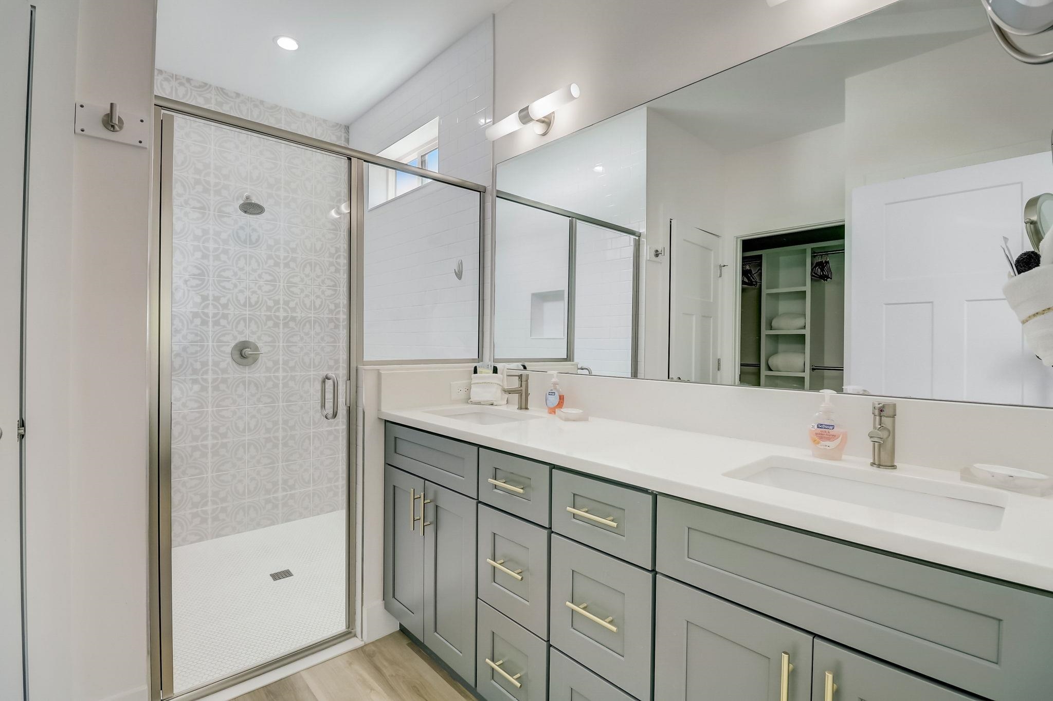 45 Menendez Road St. Augustine, FL 32080 - Photo 16 of 36 a bathroom with a shower sink double vanity and mirror