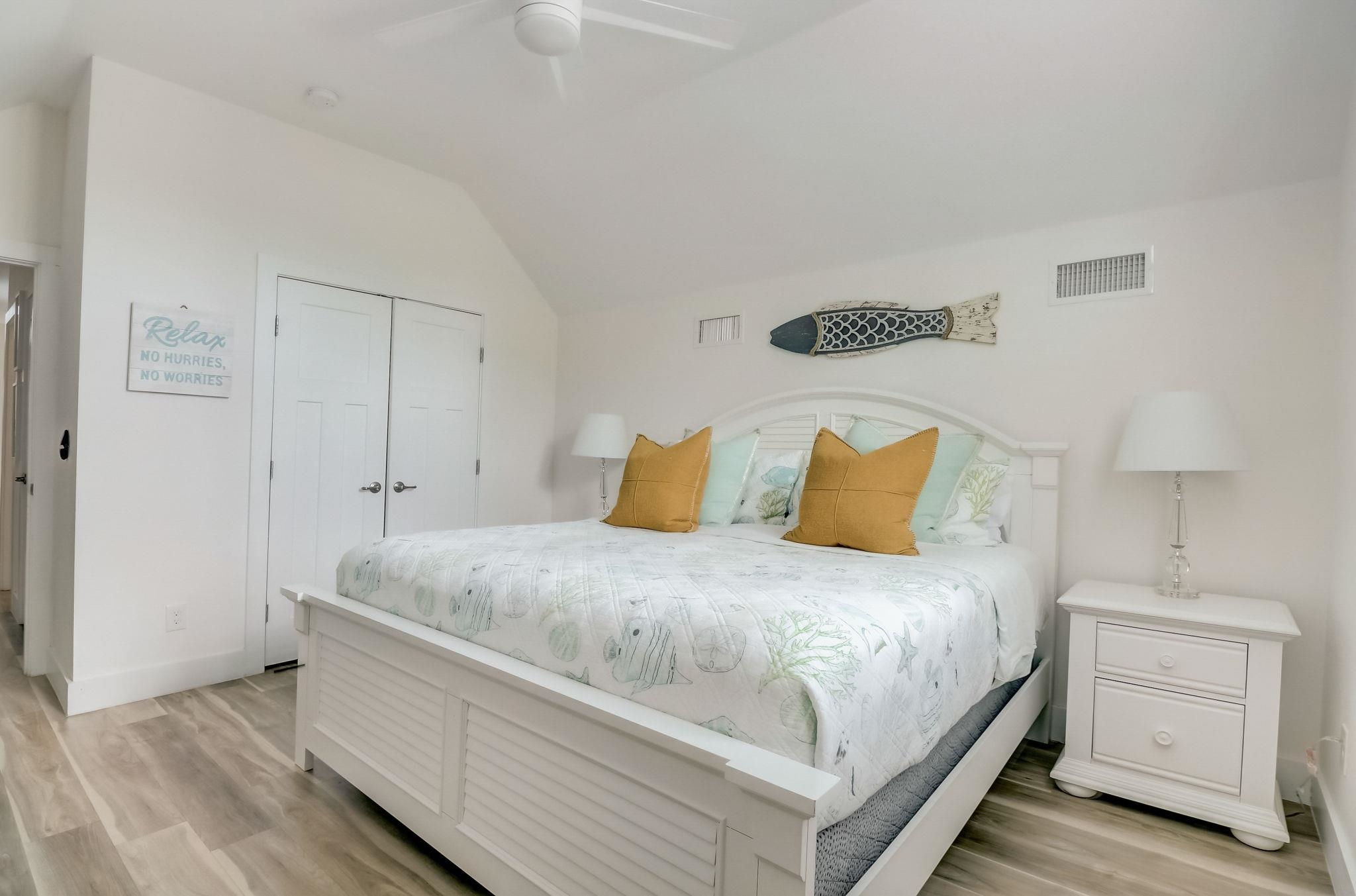 45 Menendez Road St. Augustine, FL 32080 - Photo 24 of 36 a bedroom with a bed and a lamp