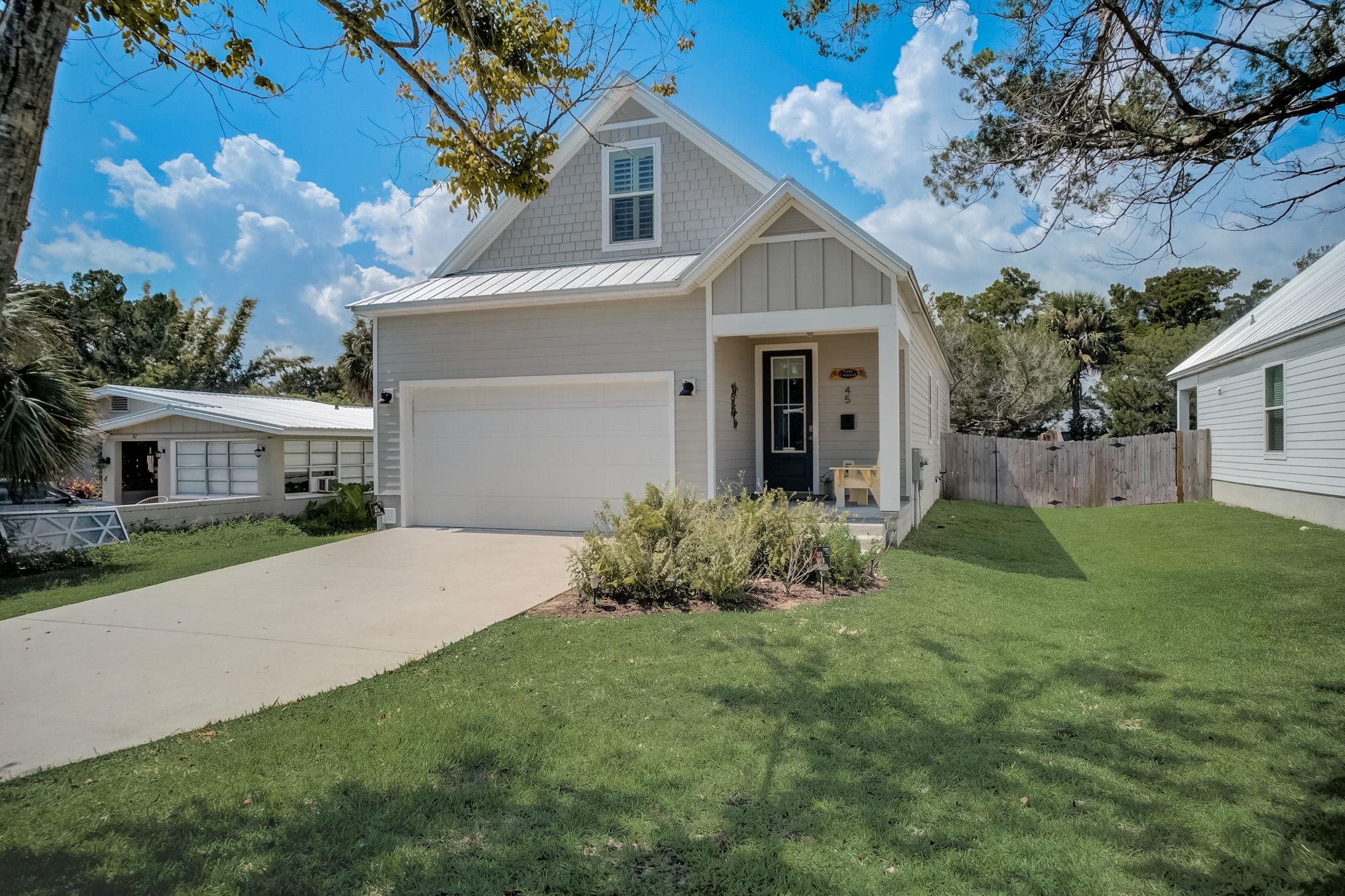 45 Menendez Road St. Augustine, FL 32080 - Photo 3 of 36 a front view of a house with garden