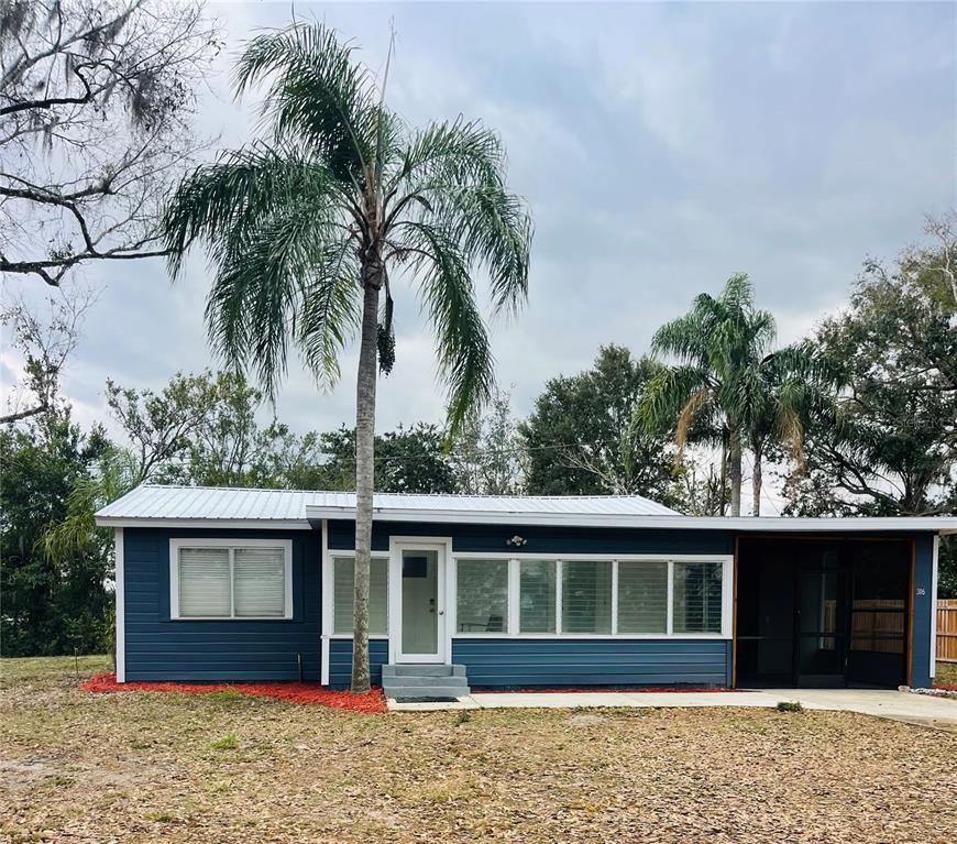 316 Brooks Road Frostproof, FL 33843 - Photo 1 of 11 a front view of a house with a garden